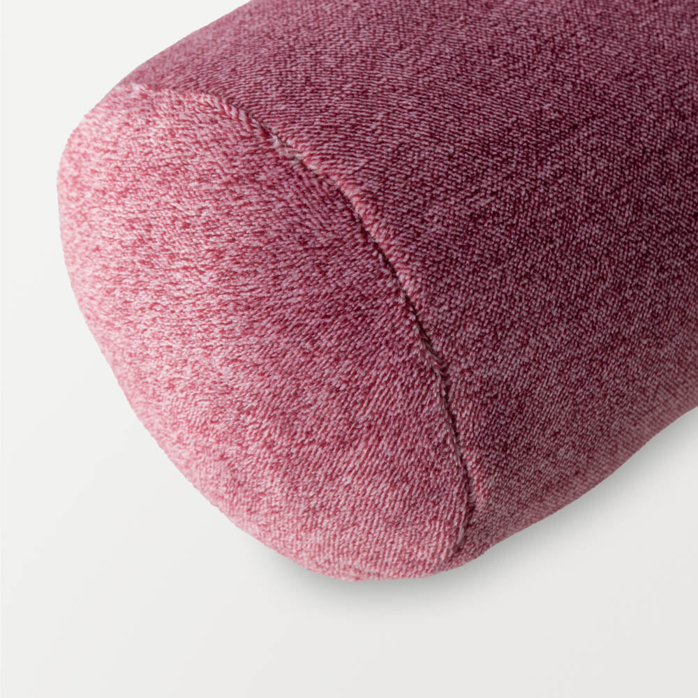 Close up of a pink neckroll pillow.