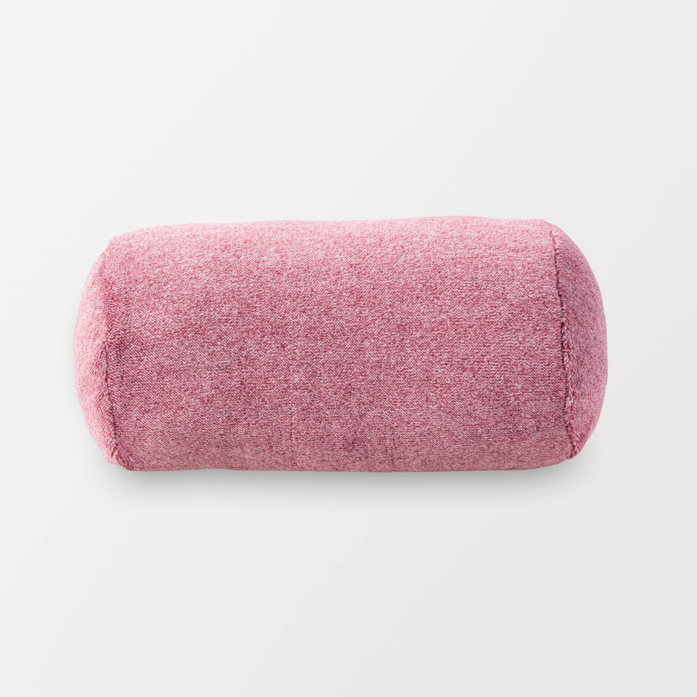 A pink neckroll pillow on a white background.