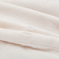 Close-up of the Cream VelvetLoft® duvet cover fabric and button closure