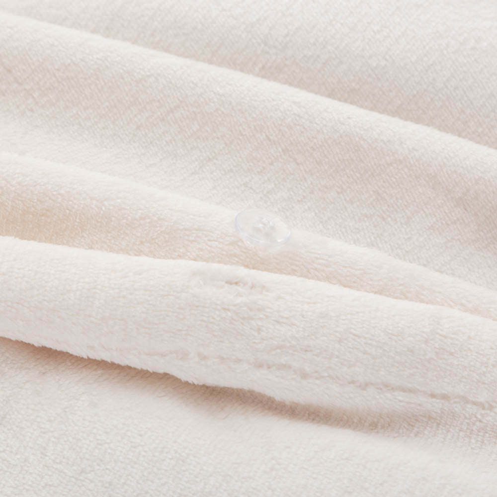 Close-up of the Cream VelvetLoft® duvet cover fabric and button closure