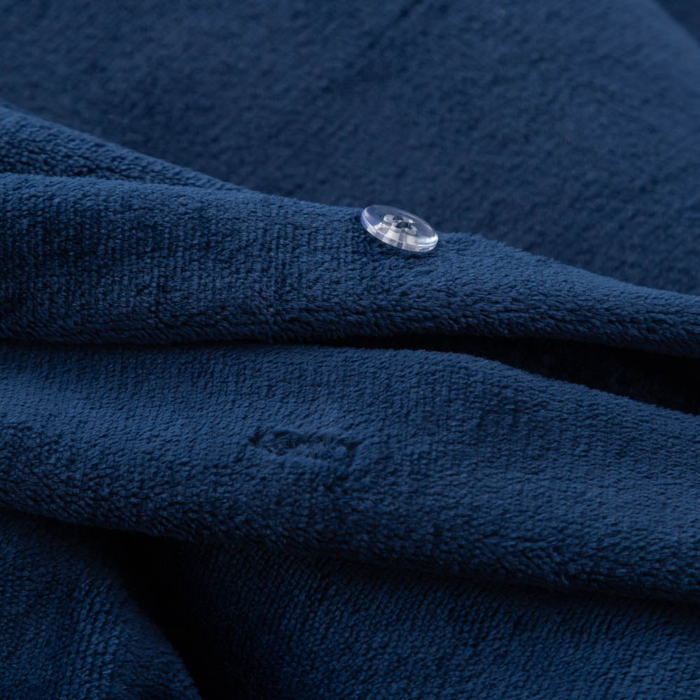 Close-up of the Dress Blue VelvetLoft® fabric and button closure of the duvet set, highlighting its plush, silky texture.