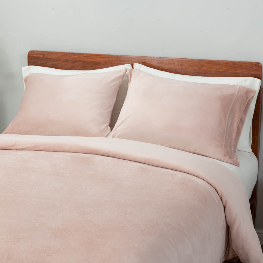 A bed styled with the VelvetLoft® Plush Duvet Cover Set, featuring two large pillow shams and the duvet cover neatly draped.