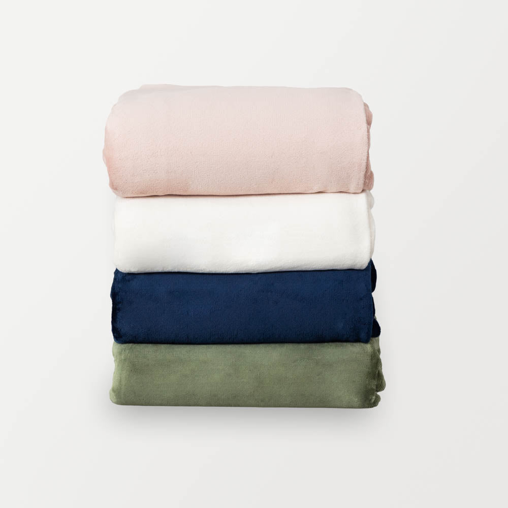 Stack of VelvetLoft® duvet covers, from top to bottom: rose smoke, cream, dress blue, dark sage