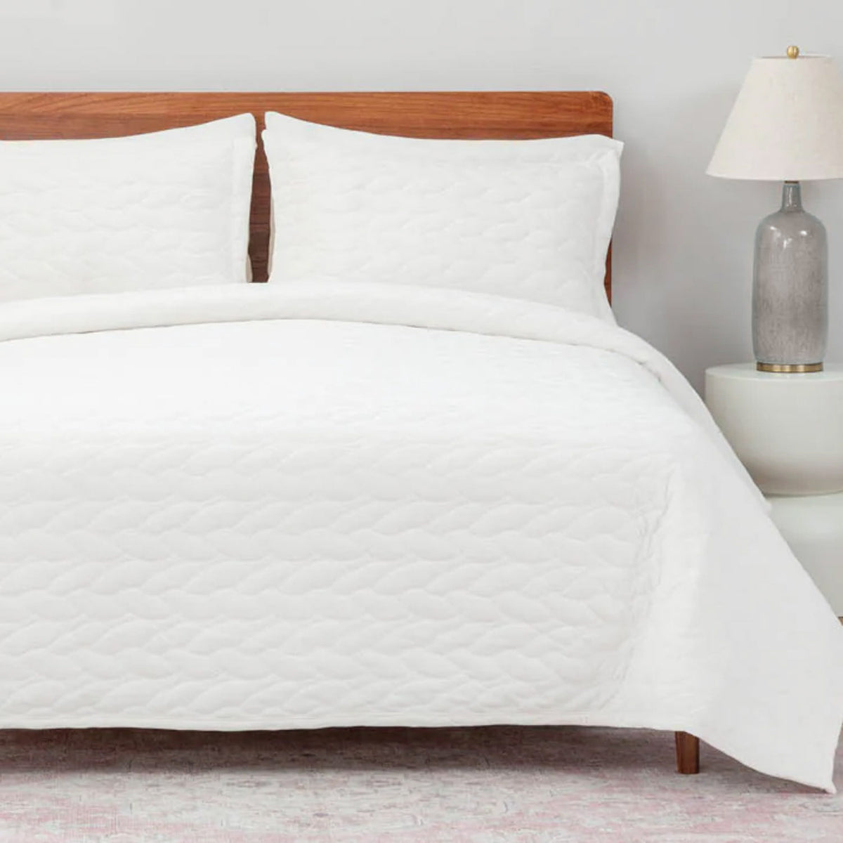 VelvetLoft® Quilt Set in White on a made bed, front view
