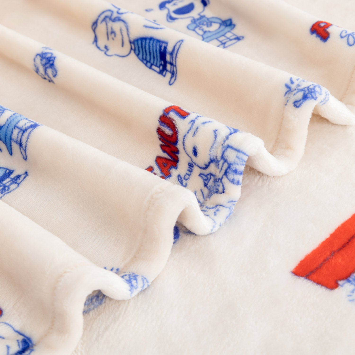 Close up of a Printed Peanuts 75th Anniversary Throw.