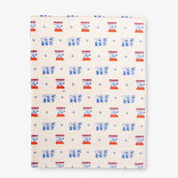 Printed Peanuts 75th Anniversary Throw laid flat on a white surface.