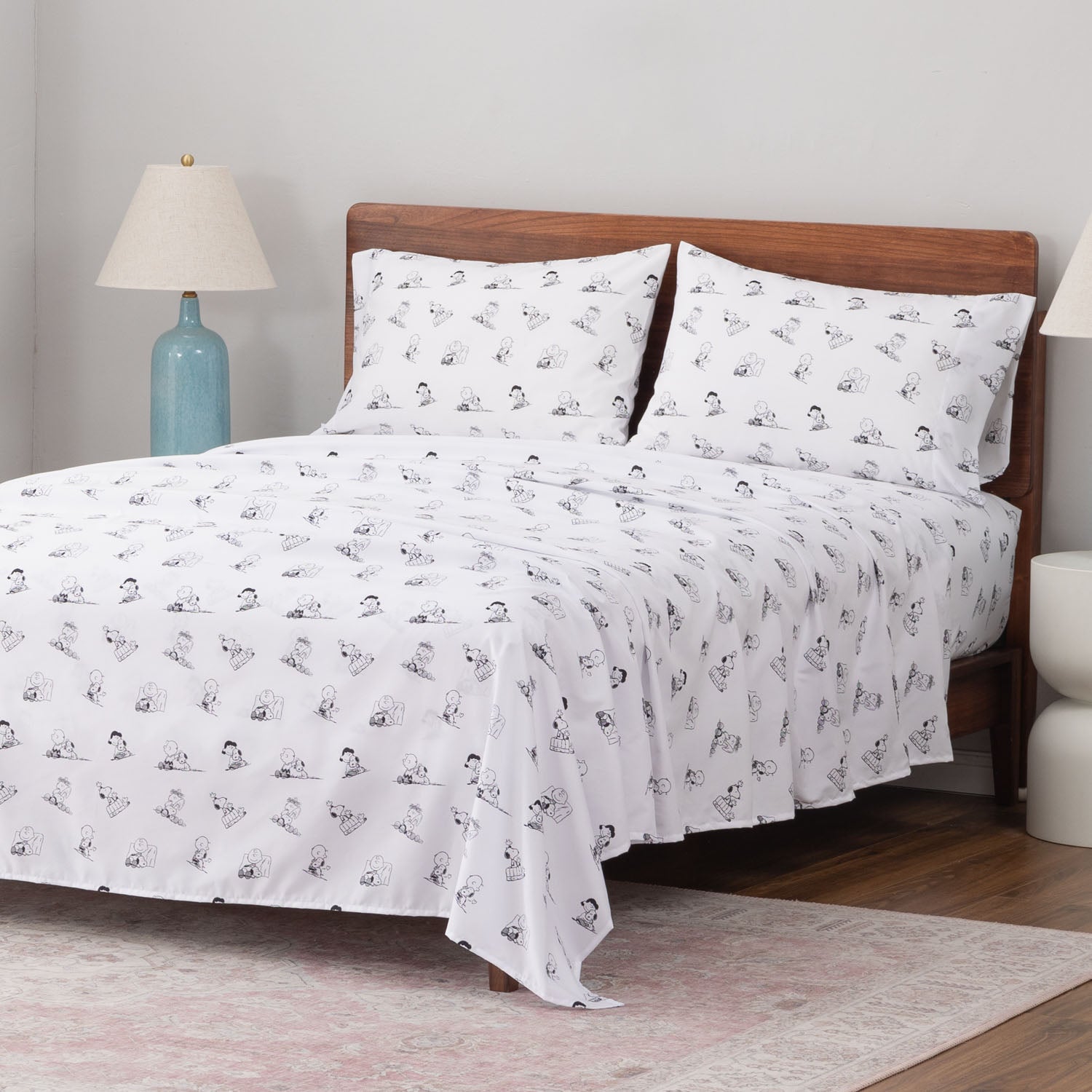 Peanuts printed microfiber sheet set dressed on a bed.