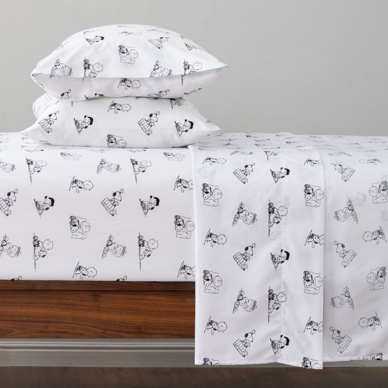 Peanuts printed microfiber sheet set dressed on a bed.