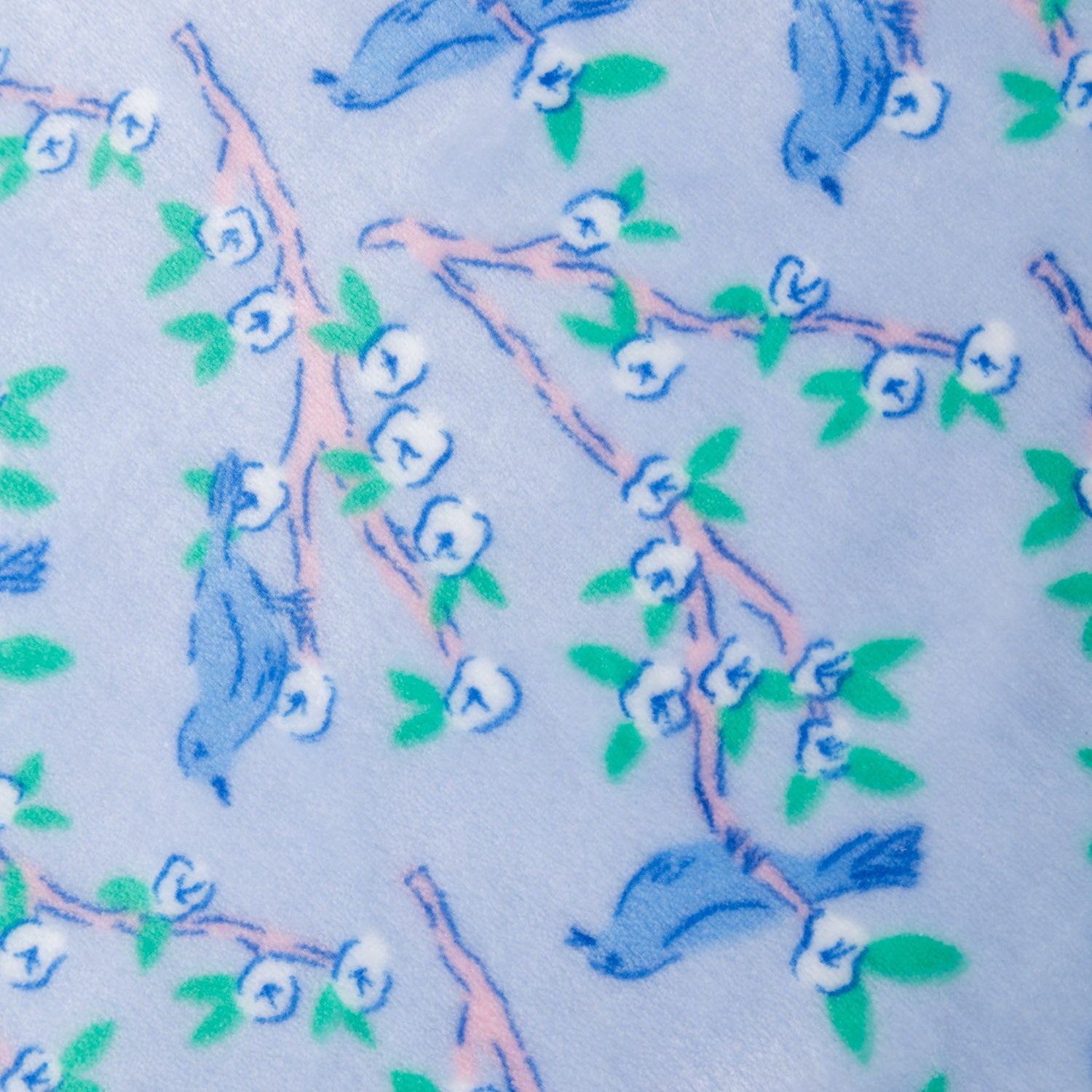 Close up of a Krissy Mast Artist Series printed cherry blossom print throw.