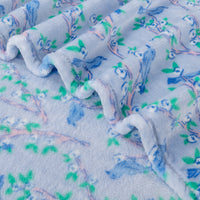 Close up of a Krissy Mast Artist Series printed cherry blossom print throw.