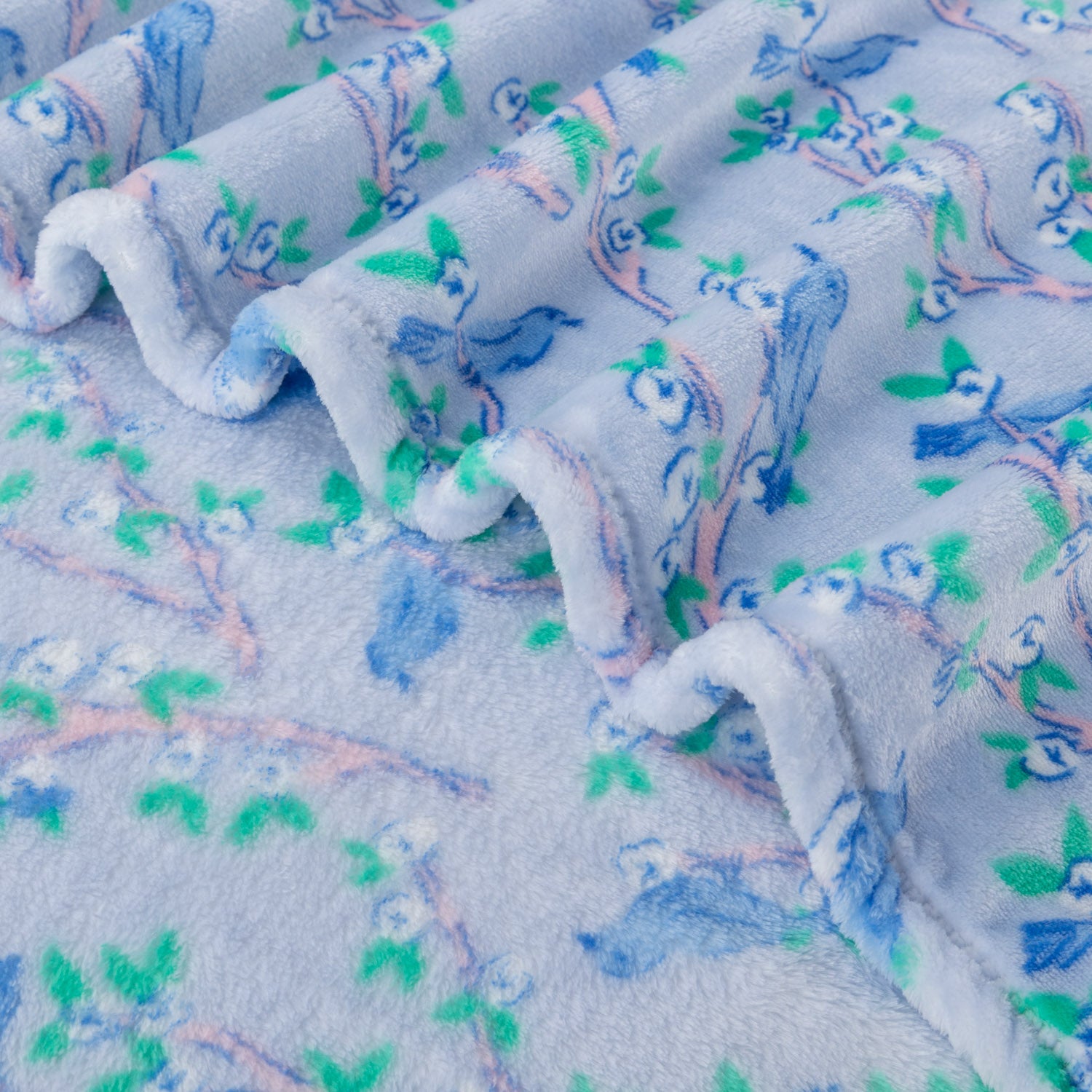 Close up of a Krissy Mast Artist Series printed cherry blossom print throw.