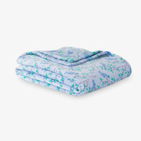 Krissy Mast Artist Series printed cherry blossom print throw folded neatly on a white surface.