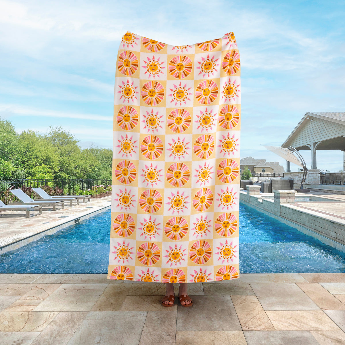 Vicky Yorke Summer Nostalgia beach towel held up by a person standing by a pool.