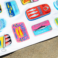 Colorful sardine can-shaped patches on a white background