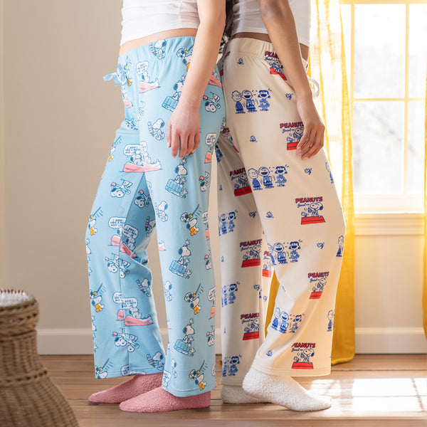 Two woman wearing Peanuts printed lounge pants.