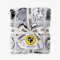 Peanuts 75th Anniversary Throw & Pillow Set sitting on a white surface.