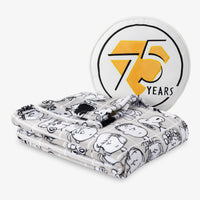 Peanuts 75th Anniversary Throw & Pillow Set draped sitting on a white surface.