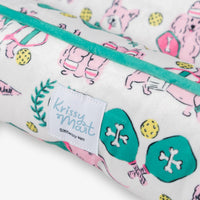 Krissy Mast pickleball pups dog toy and pet bed set on a white surface.