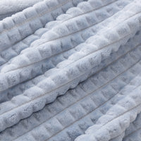 Close up of a blue waffle blanket.