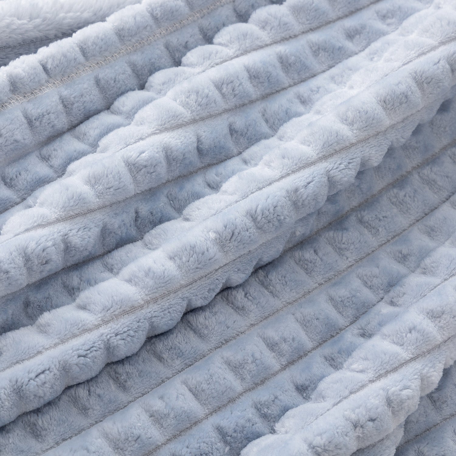 Close up of a blue waffle blanket.