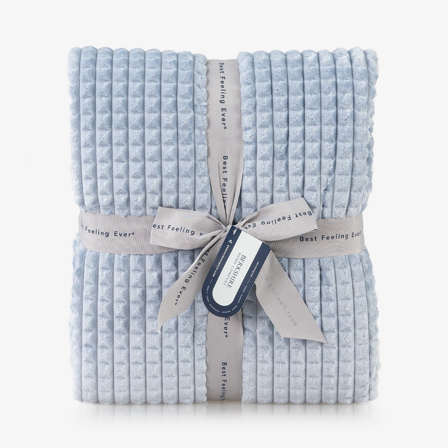 A blue waffle blanket folded neatly on a white surface.