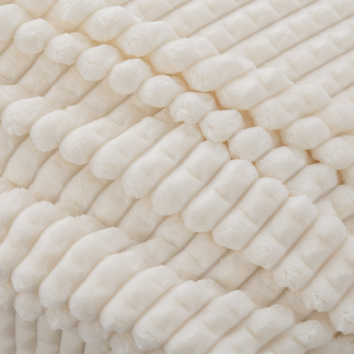 A close up of a cream VelvetLoft waffle blanket.