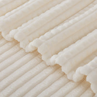 A close up of a cream VelvetLoft waffle blanket.