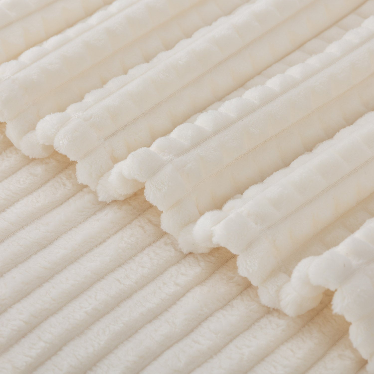 A close up of a cream VelvetLoft waffle blanket.