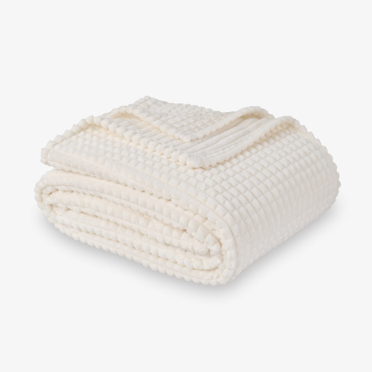 A cream VelvetLoft waffle blanket folded neatly on a white surface.