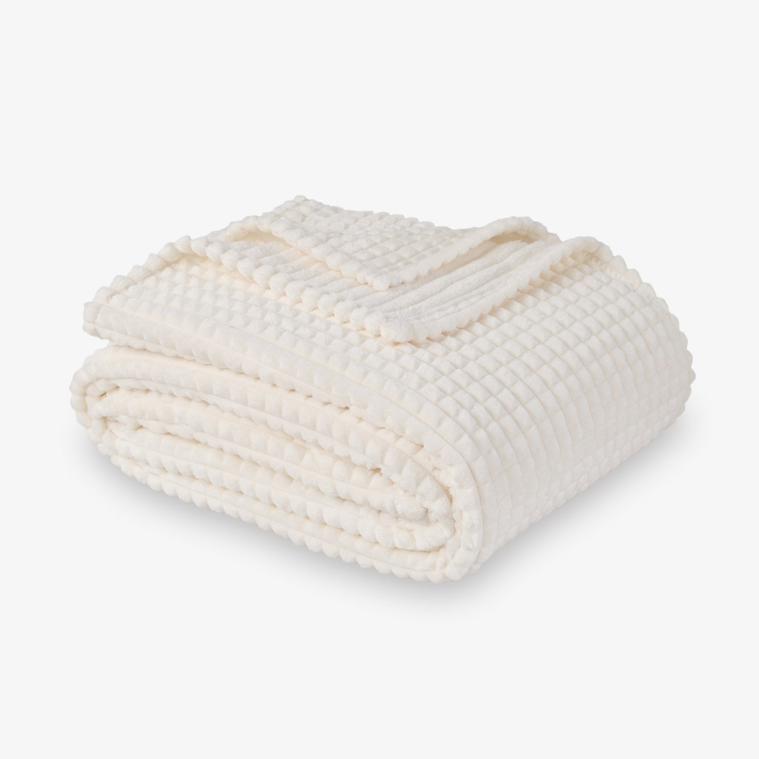 A cream VelvetLoft waffle blanket folded neatly on a white surface.