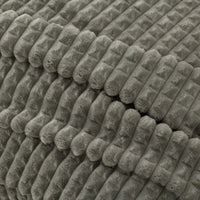 A close up of a sage green VelvetLoft waffle blanket.