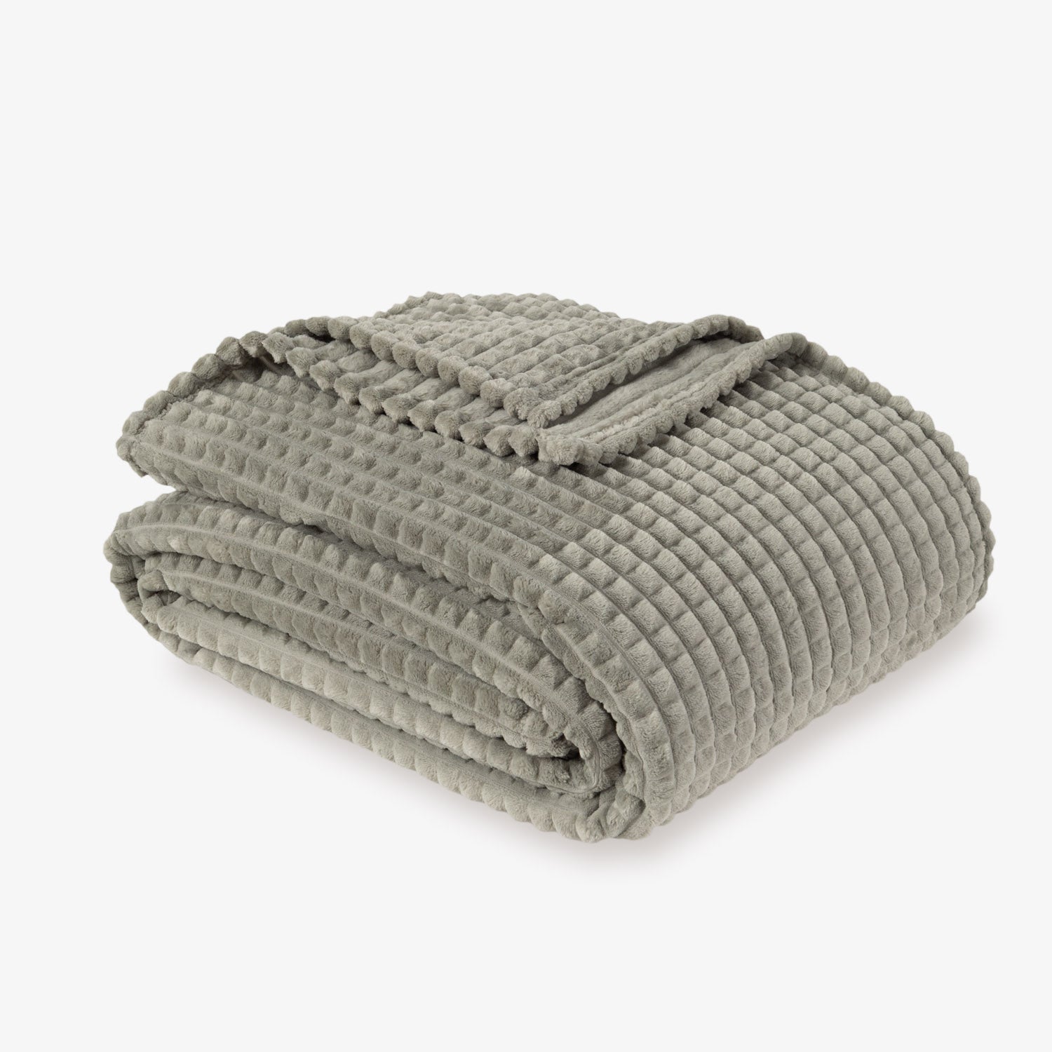 A sage green VelvetLoft waffle blanket folded neatly on a white surface.