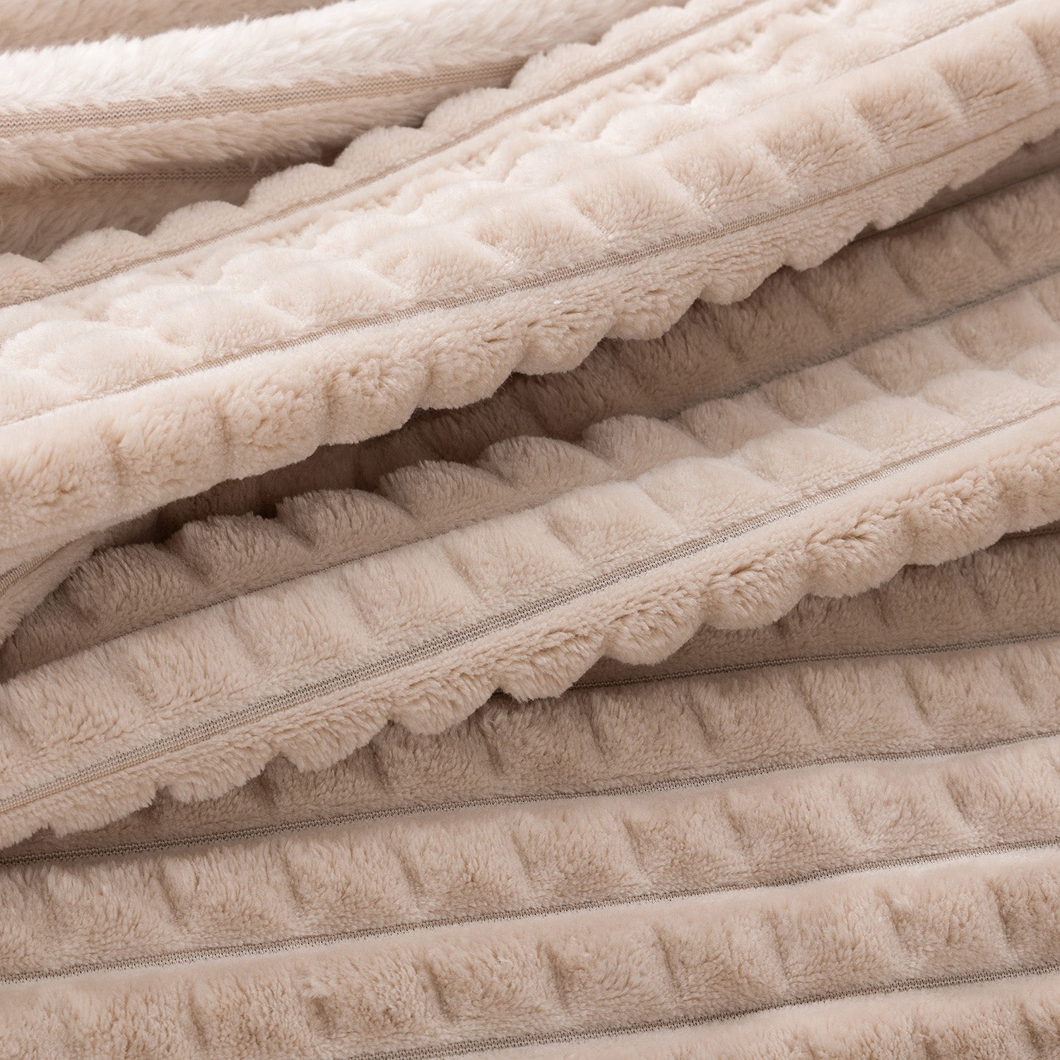 A close up of a tan waffle blanket.
