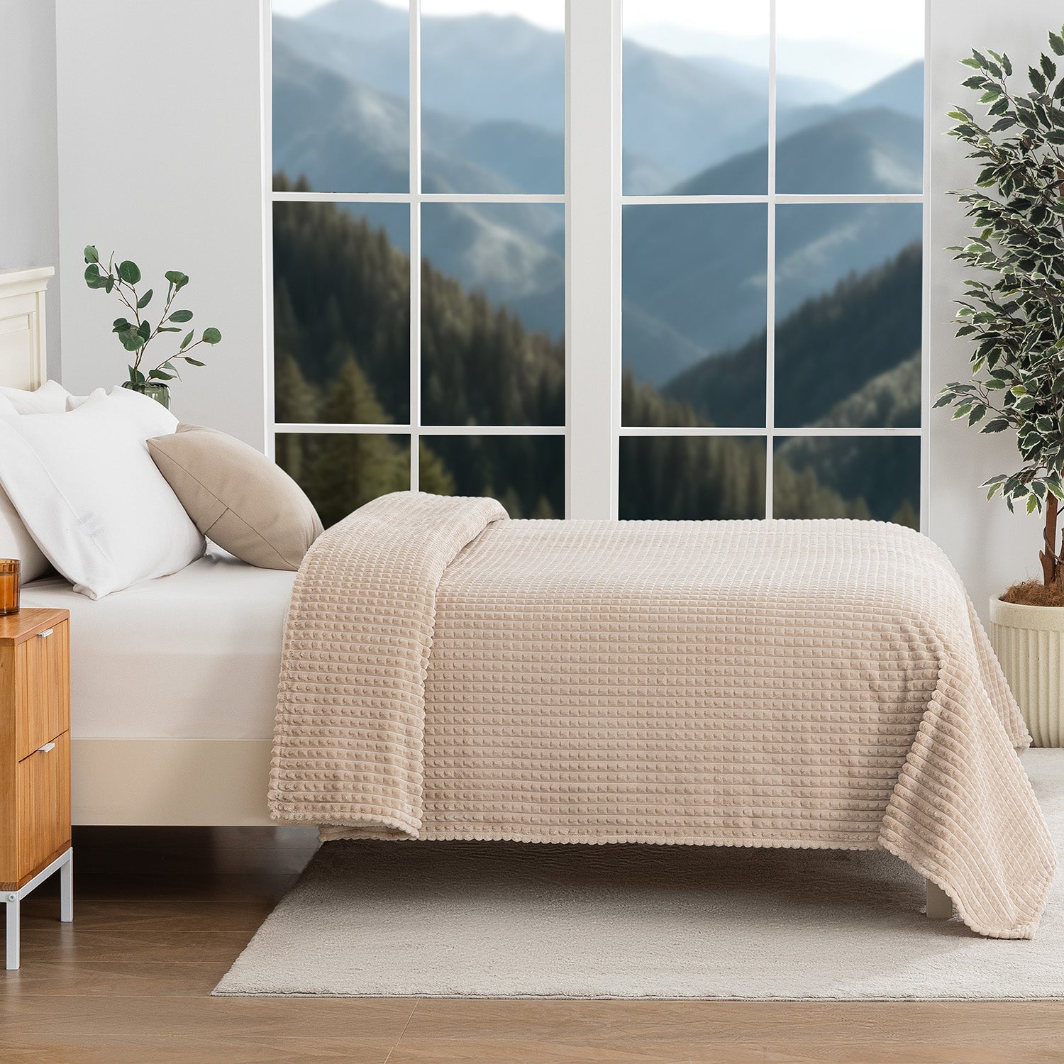A tan waffle blanket decorated neatly on a bed with a scenic background.