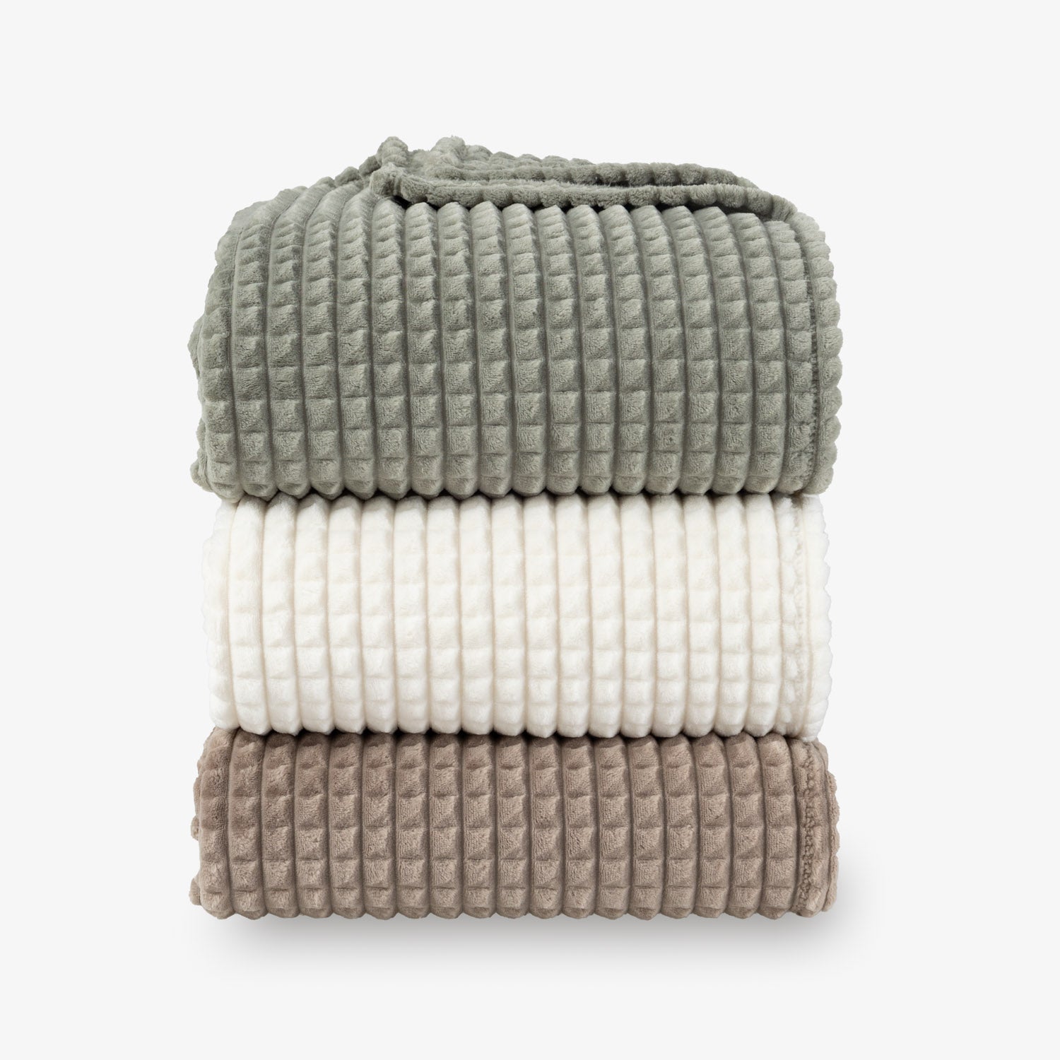 A stack of a green, cream, and brown VelvetLoft waffle blanket on a white surface.