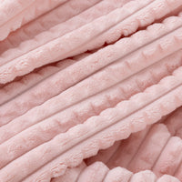 A close up of a pink waffle blanket.
