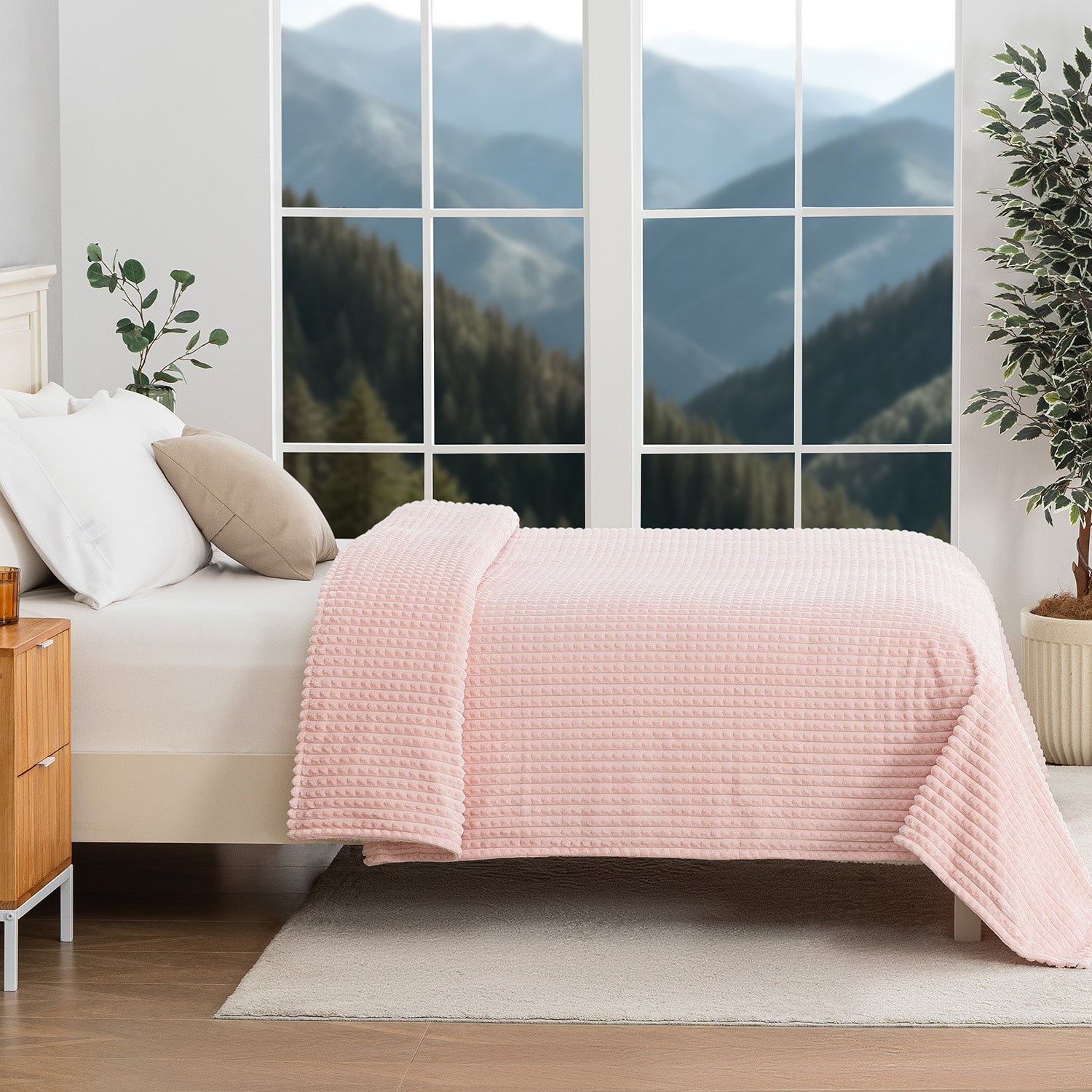 Pink textured blanket decorated neatly on a bed with a scenic background.