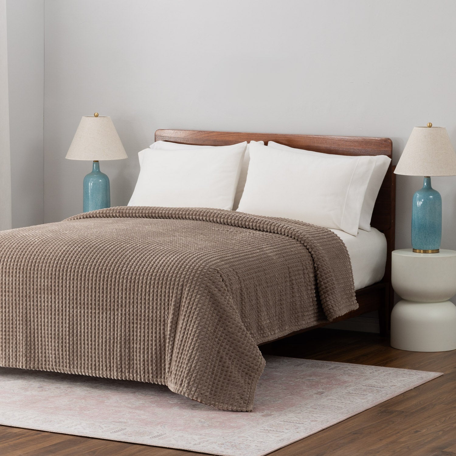 A brown VelvetLoft waffle blanket dressed neatly on a bed.