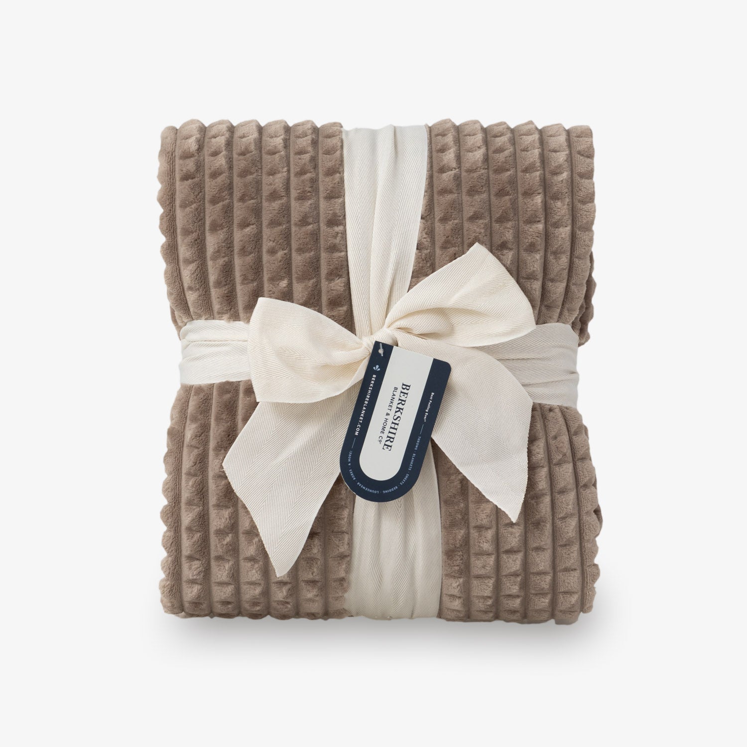 A brown VelvetLoft waffle blanket folded neatly on a white surface.