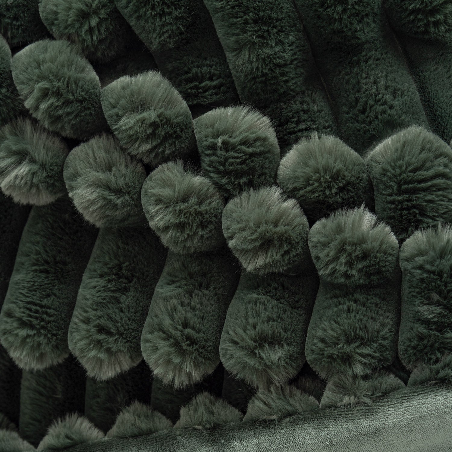 Close-up of dark green textured fabric with a pattern