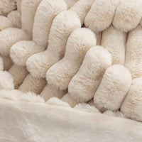 Close-up of a textured beige throw.