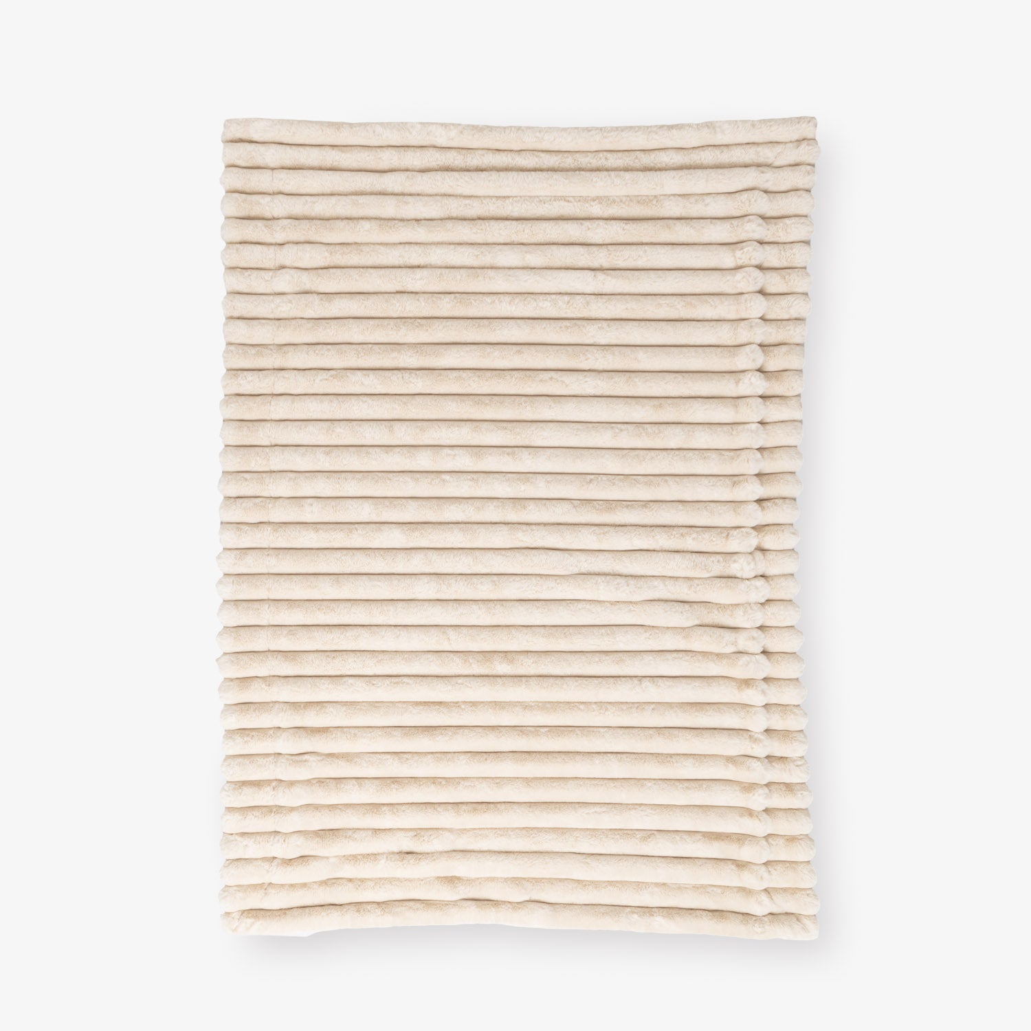 Beige textured throw laid flat on a white background