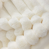 Close-up of white textured throw blanket.