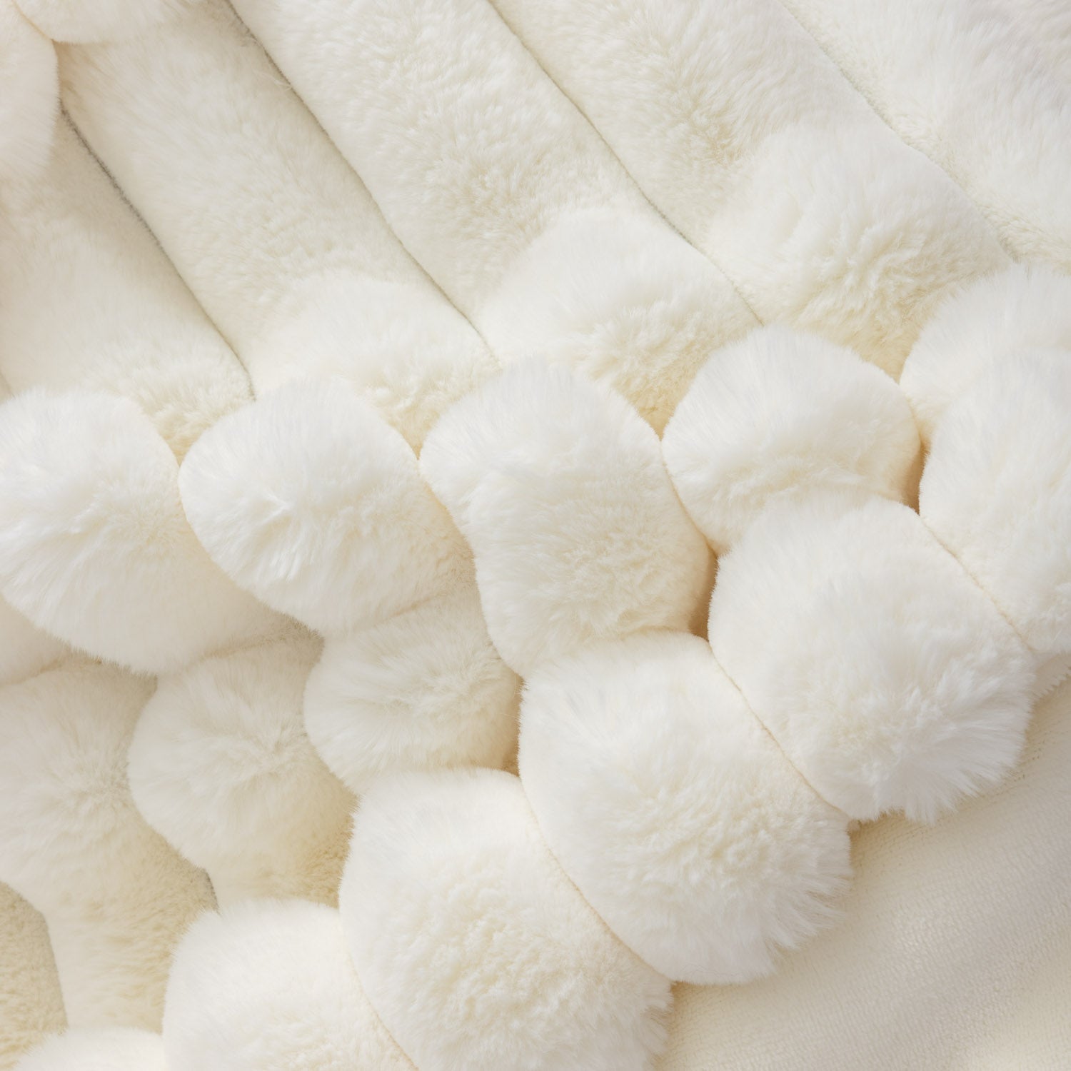 Close-up of white textured throw blanket.