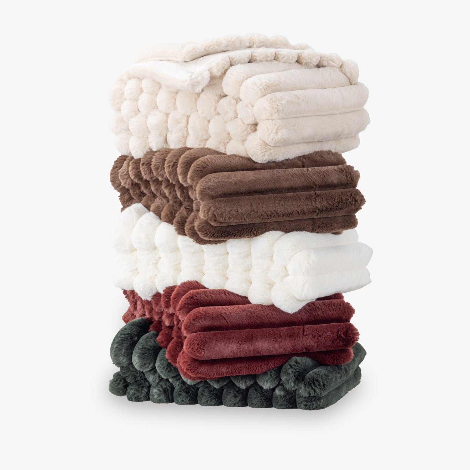 Stack of colorful textured throw blankets on a white background
