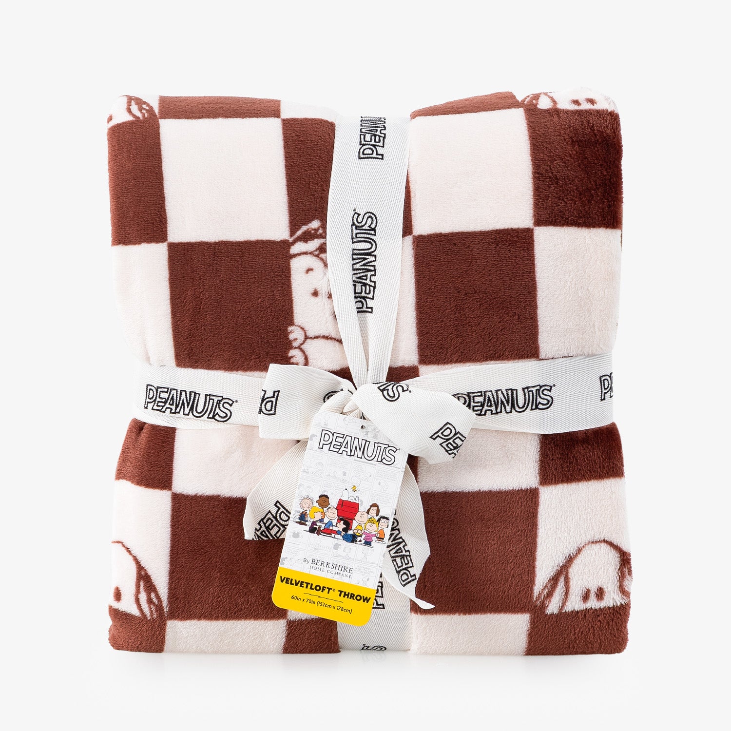A folded plush throw blanket with a brown and cream checkered pattern, featuring cartoon Peanuts characters. The blanket is wrapped in a white ribbon printed with the 'Peanuts' brand name and tied with a paper hangtag.