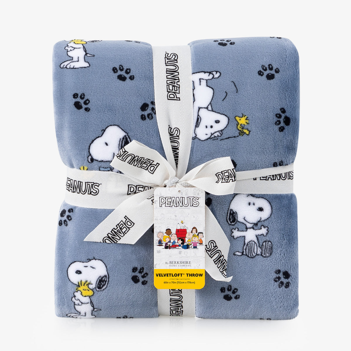 A folded light blue plush throw blanket with a Peanuts character print, wrapped in a white ribbon with the Peanuts logo and a yellow tag.