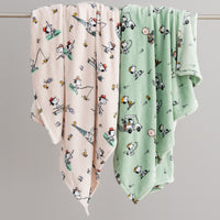 Two baby blankets with cartoon patterns on a gray background