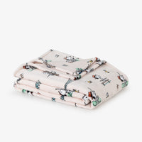 Folded blanket with cartoon design on a white background