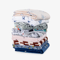 Stack of a variety of peanuts printed throws.